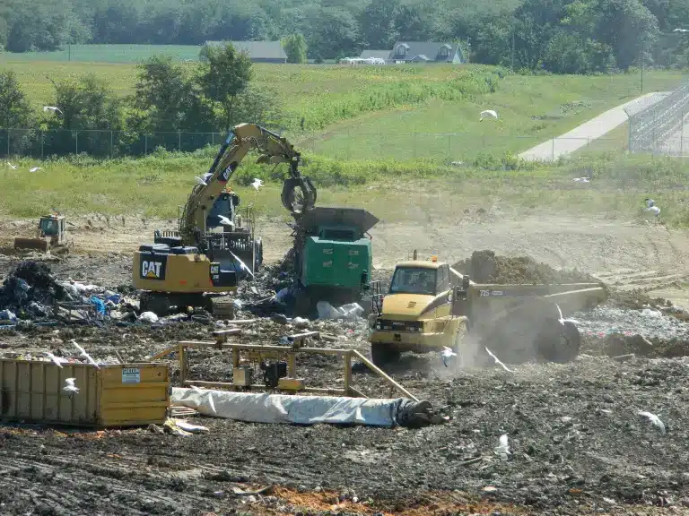 Landfill with CAT machines burying trash